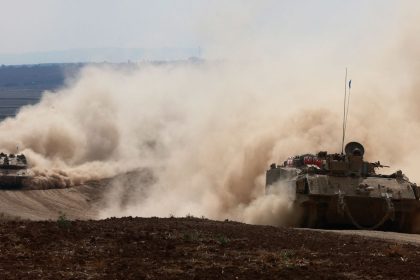 Israeli army tanks drive in an area near Israel's southern border with the Gaza Strip on October 6.