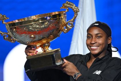 Coco Gauff celebrates with the trophy after winning the women's singles final match against Czech Republic's Karolina Muchova at the China Open.