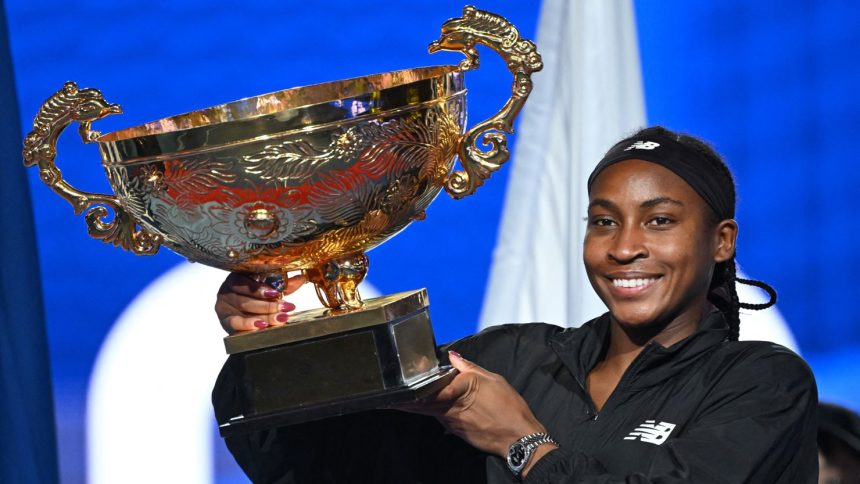 Coco Gauff celebrates with the trophy after winning the women's singles final match against Czech Republic's Karolina Muchova at the China Open.