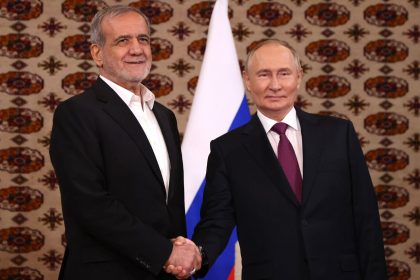 Putin and Pezeshkian shake hands during their first meeting, held Friday in Ashgabat, Turkmenistan.