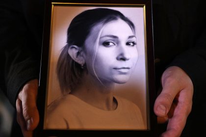 A colleague of Ukrainian journalist Victoria Roshchyna holds a photograph of her during a memorial event in Kyiv.