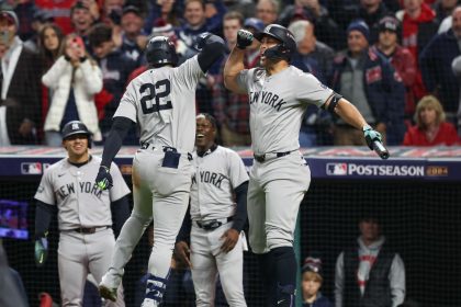 New York Yankees sluggers Juan Soto (22) and Giancarlo Stanton (27) celebrate during a game against the Cleveland Guardians in Game 5 of the ALCS.