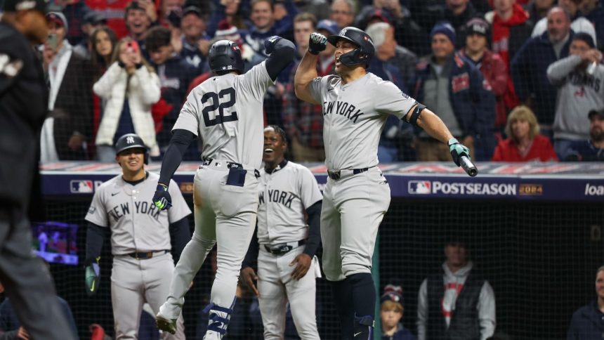 New York Yankees sluggers Juan Soto (22) and Giancarlo Stanton (27) celebrate during a game against the Cleveland Guardians in Game 5 of the ALCS.