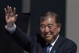 Shigeru Ishiba, Japan's prime minister, waves as he delivers a campaign speech in Osaka, Japan, on October 20, 2024.