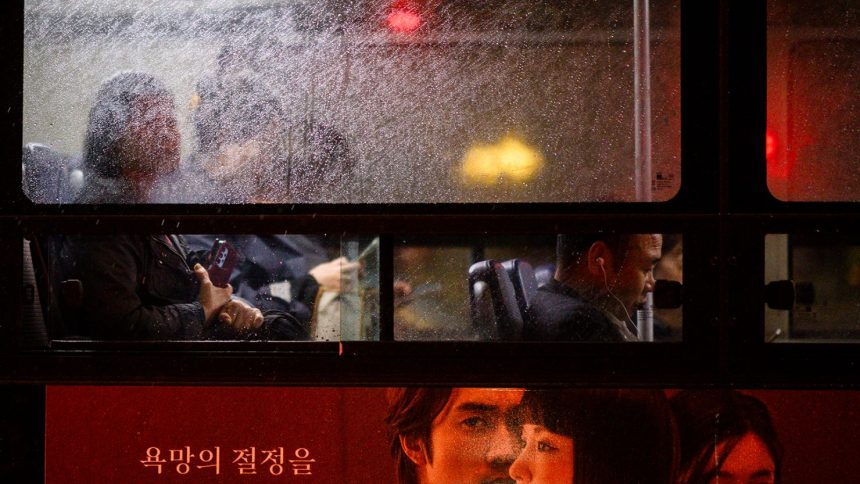 Commuters travel in a bus as it rains in Seoul, South Korea, on October 22, 2024.