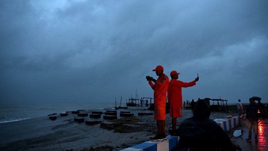 National Disaster Response Force personnel stand guard a beach near Digha, India on October 24, 2024, ahead of cyclone Dana's landfall.