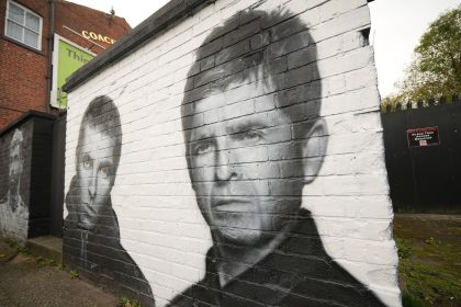 A mural depicting Liam and Noel Gallagher by artist Snow Graffiti adorns a wall at the Coach and Horses pub in Whitefield on October 21, 2024 in Manchester, England.