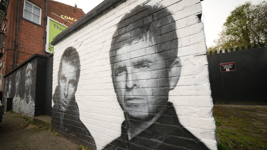 A mural depicting Liam and Noel Gallagher by artist Snow Graffiti adorns a wall at the Coach and Horses pub in Whitefield on October 21, 2024 in Manchester, England.