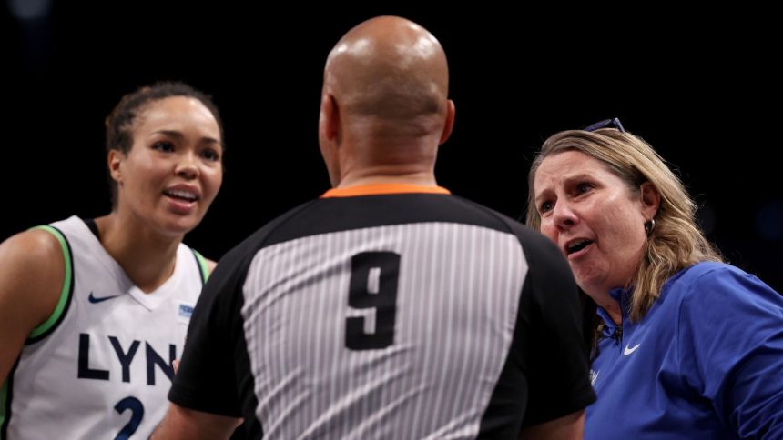 Minnesota Lynx forward Napheesa Collier and head coach Cheryl Reeve discuss a foul call with a game official in the fourth quarter of Game Five of the WNBA Finals.