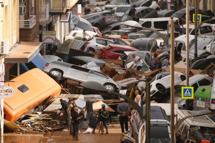 Cars are piled in the street with other debris in Valencia, Spain after flash floods hit the region.