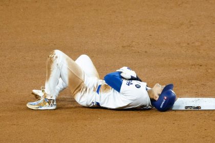 Shohei Ohtani of the Los Angeles Dodgers lies on the ground injured after attempting to steal second base in the seventh inning during Game 2 of the 2024 World Series at Dodger Stadium on Saturday in Los Angeles, California.