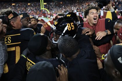 Washington Commanders players celebrate Noah Brown's game-winning Hail Mary touchdown catch to beat the Chicago Bears.