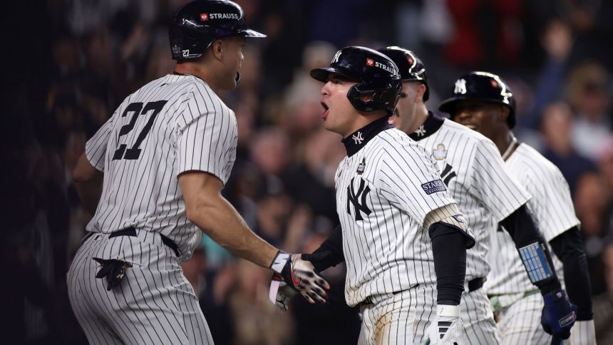 Anthony Volpe is congratulated by his teammates after hitting a grand slam in Game 4.