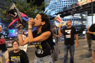 Demonstrators block a major thoroughfare in Tel Aviv on October 19, 2024, protesting against the government and demanding a ceasefire deal.