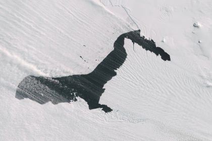 Steam fog, also known as sea smoke, along with blowing bands of snow (cottony white) are seen in contrast to the water of Pine Island Glacier in Antarctica on October 10, 2024.