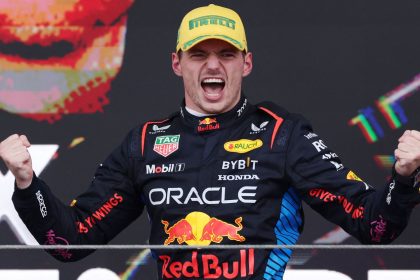 Red Bull's Max Verstappen celebrates on the podium after winning the Sao Paulo Grand Prix.