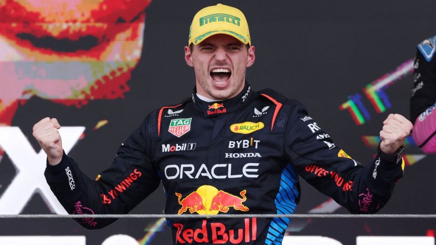 Red Bull's Max Verstappen celebrates on the podium after winning the Sao Paulo Grand Prix.