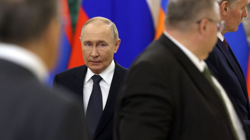 Russian President Vladimir Putin enters the hall of the Grand Kremlin Palace in Moscow during a summit of ex-Soviet states on October 8.