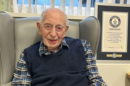 John Tinniswood pictured with his Guinness World Records certificate as the world's oldest living man.