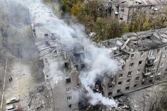 In this image provided by the Ukrainian Emergency Service on Monday, Nov. 11, 2024, a smoke rises out of an apartments building after a Russian attack in Kryvyi Rih, Ukraine. (Ukrainian Emergency Service via AP)