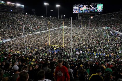 Ducks fans rush the field after Oregon beat the Ohio State Buckeyes in Eugene, Oregon, last month.