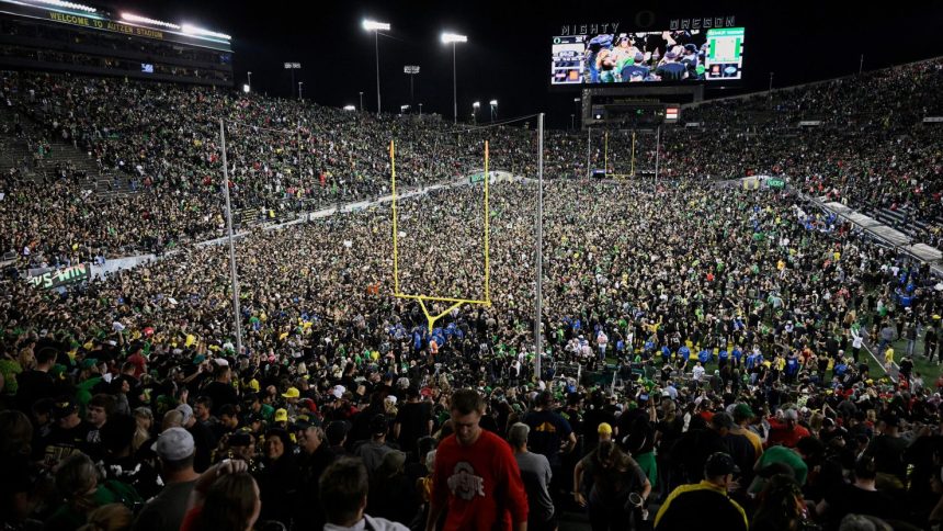 Ducks fans rush the field after Oregon beat the Ohio State Buckeyes in Eugene, Oregon, last month.