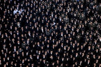 Ultra-Orthodox Jewish men in Jerusalem protest a Supreme Court ruling that they cannot be exempt from military service in June, 2024.