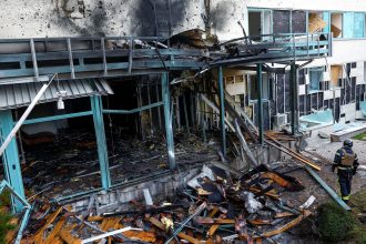 A firefighter responds to damage at a medical center after a Russian drone strike on Kyiv, Ukraine, on Thursday.