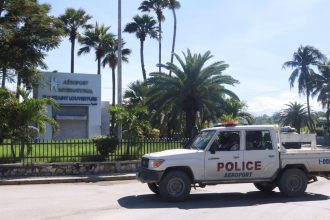 A police vehicle drives outside Toussaint Louverture International Airport.