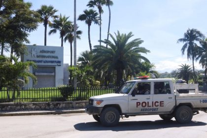 A police vehicle drives outside Toussaint Louverture International Airport.