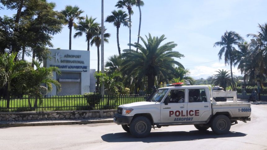 A police vehicle drives outside Toussaint Louverture International Airport.