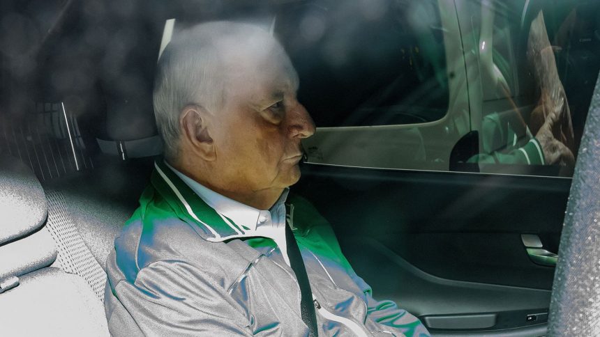 Alan Jones is seen in the back of an unmarked police car as he is transferred to Day St Police Station, in Sydney, Australia on November 18, 2024.