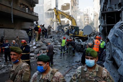 Civil defense members work as Lebanese army soldiers stand guard at the site of an Israeli strike in the Basta neighborhood of Beirut, Lebanon, on November 23, 2024.