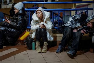 People take shelter inside a metro station in Kyiv during Russia's overnight attack.