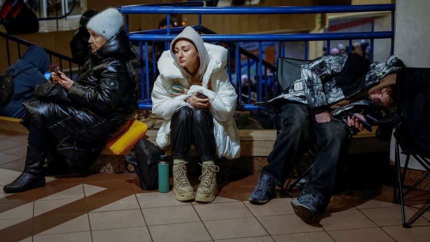 People take shelter inside a metro station in Kyiv during Russia's overnight attack.