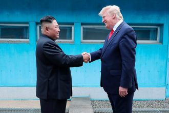 North Korean leader Kim Jong Un and U.S. then-President Donald Trump shake hands over the military demarcation line between North and South Korea on June 30, 2019.