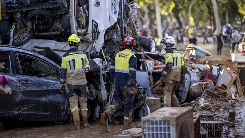 Firefighters search for people among cars in Alfafar, Valencia, on November 2.