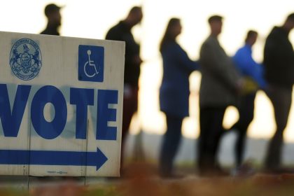 Voters wait in line to cast their ballots at Scranton High School in Scranton, Pennsylvania, on Election Day, Tuesday, November 5, 2024.