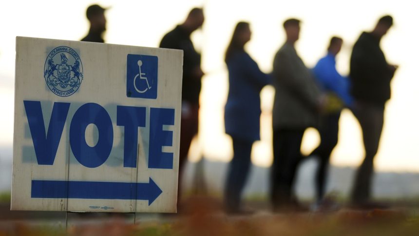 Voters wait in line to cast their ballots at Scranton High School in Scranton, Pennsylvania, on Election Day, Tuesday, November 5, 2024.