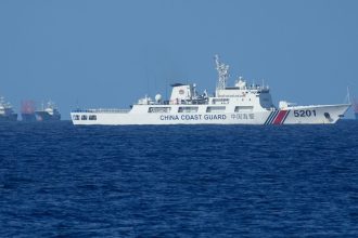 A Chinese coast guard vessel stays beside suspected Chinese militia ships near Thitu island, locally called Pag-asa Island on November 6, 2024 ahead of a Philippine military multi-service joint exercise at the disputed South China Sea, Philippines.