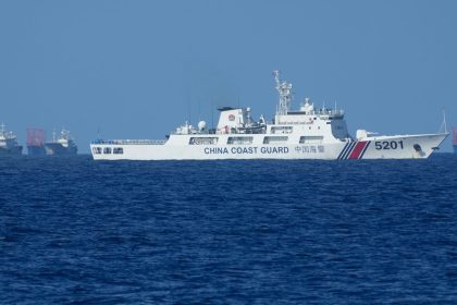 A Chinese coast guard vessel stays beside suspected Chinese militia ships near Thitu island, locally called Pag-asa Island on November 6, 2024 ahead of a Philippine military multi-service joint exercise at the disputed South China Sea, Philippines.