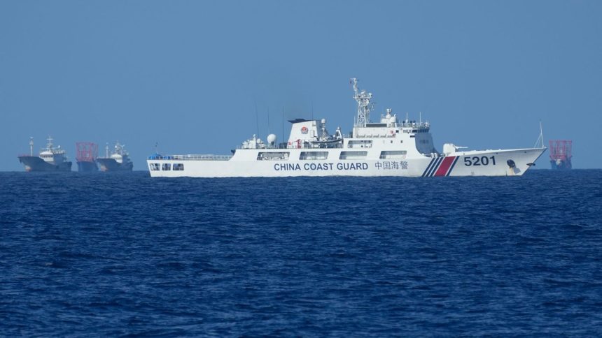 A Chinese coast guard vessel stays beside suspected Chinese militia ships near Thitu island, locally called Pag-asa Island on November 6, 2024 ahead of a Philippine military multi-service joint exercise at the disputed South China Sea, Philippines.