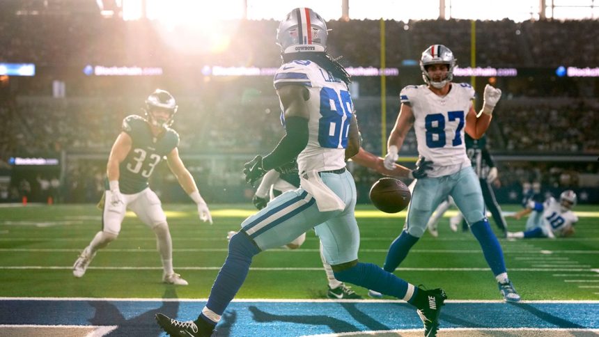 Dallas Cowboys wide receiver CeeDee Lamb misses a potential three-yard touchdown pass from quarterback Cooper Rush because of sun glare.