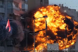 Smoke and flames erupt from a building hit in an Israeli airstrike in Tayouneh, Beirut, Lebanon, November 15, 2024.