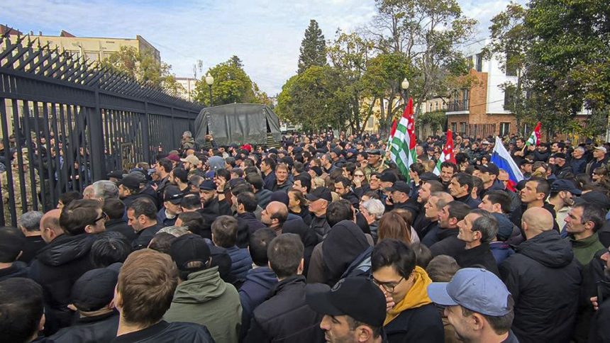 Protesters gather outside the parliament building of the Georgian separatist region of Abkhazia on Friday.