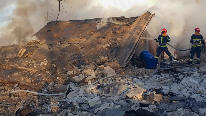 Emergency services personnel work to extinguish a fire following a Russian rocket attack in Lviv, Ukraine, on November 17.