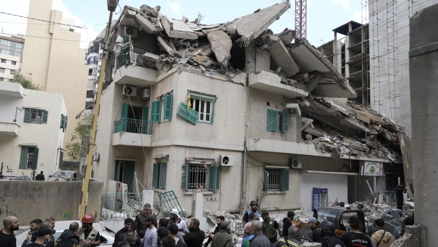 Residents and rescuers gather at the site of an Israeli airstrike that hit a building in central Beirut's Ras el-Nabaa neighborhood, Lebanon on Sunday.