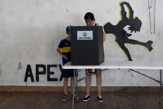 A voter marks the ballot in the presidential run-off election in Montevideo, Uruguay, Sunday, Nov. 24, 2024.