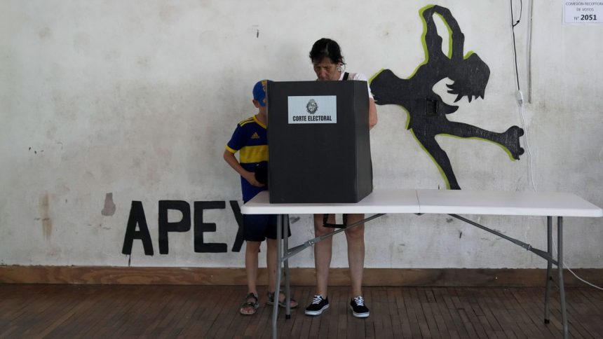 A voter marks the ballot in the presidential run-off election in Montevideo, Uruguay, Sunday, Nov. 24, 2024.