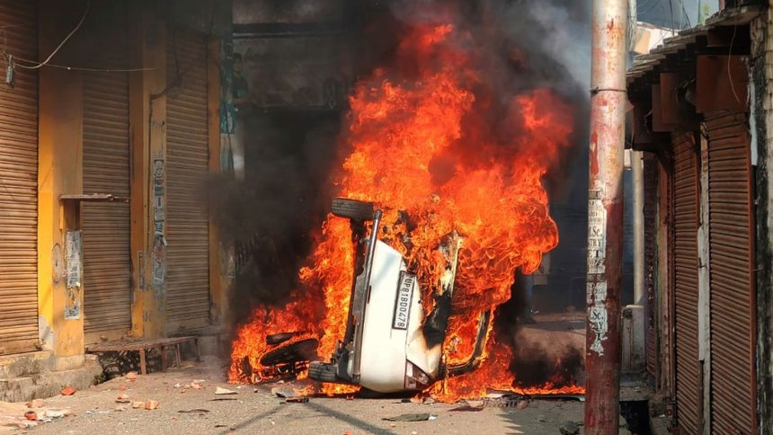 A vehicle burns during a clash between protesters and police in Sambhal, in the northern Indian state of Uttar Pradesh, on November 24, 2024.